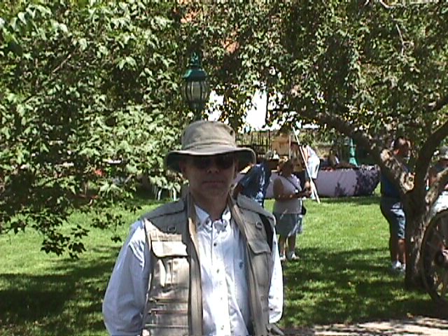 Marty wearing hat and vest in the shade