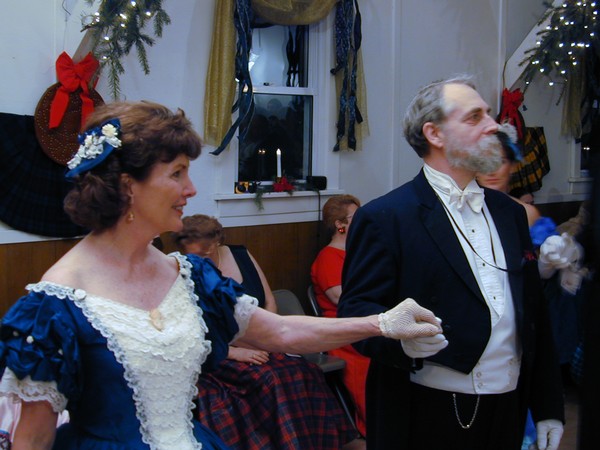 Victorian-era dancers in formal attire