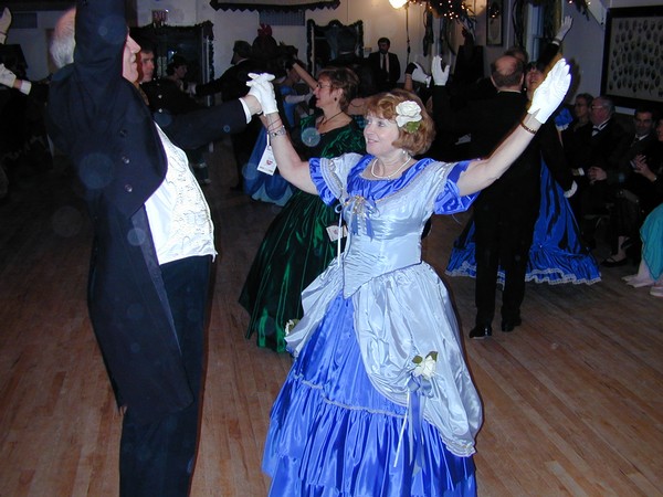 Dancers throw arms up at the completion of a dance