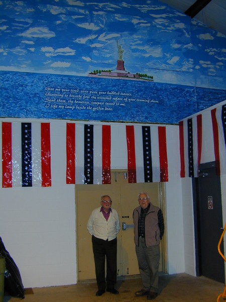 Gunther Finken and Bill Cawthon stand under Gunther's mural
