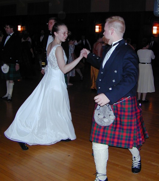 Lady in White Dress and Man in Kilt Dance